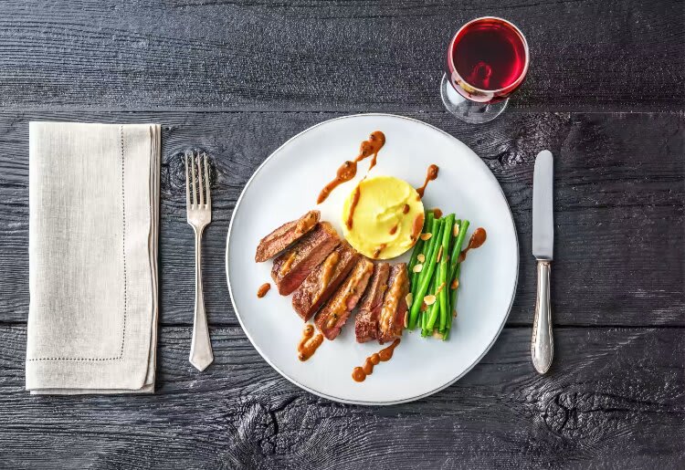 New York Strip Steak with Truffled Mashed Potatoes and Green Beans Almandine